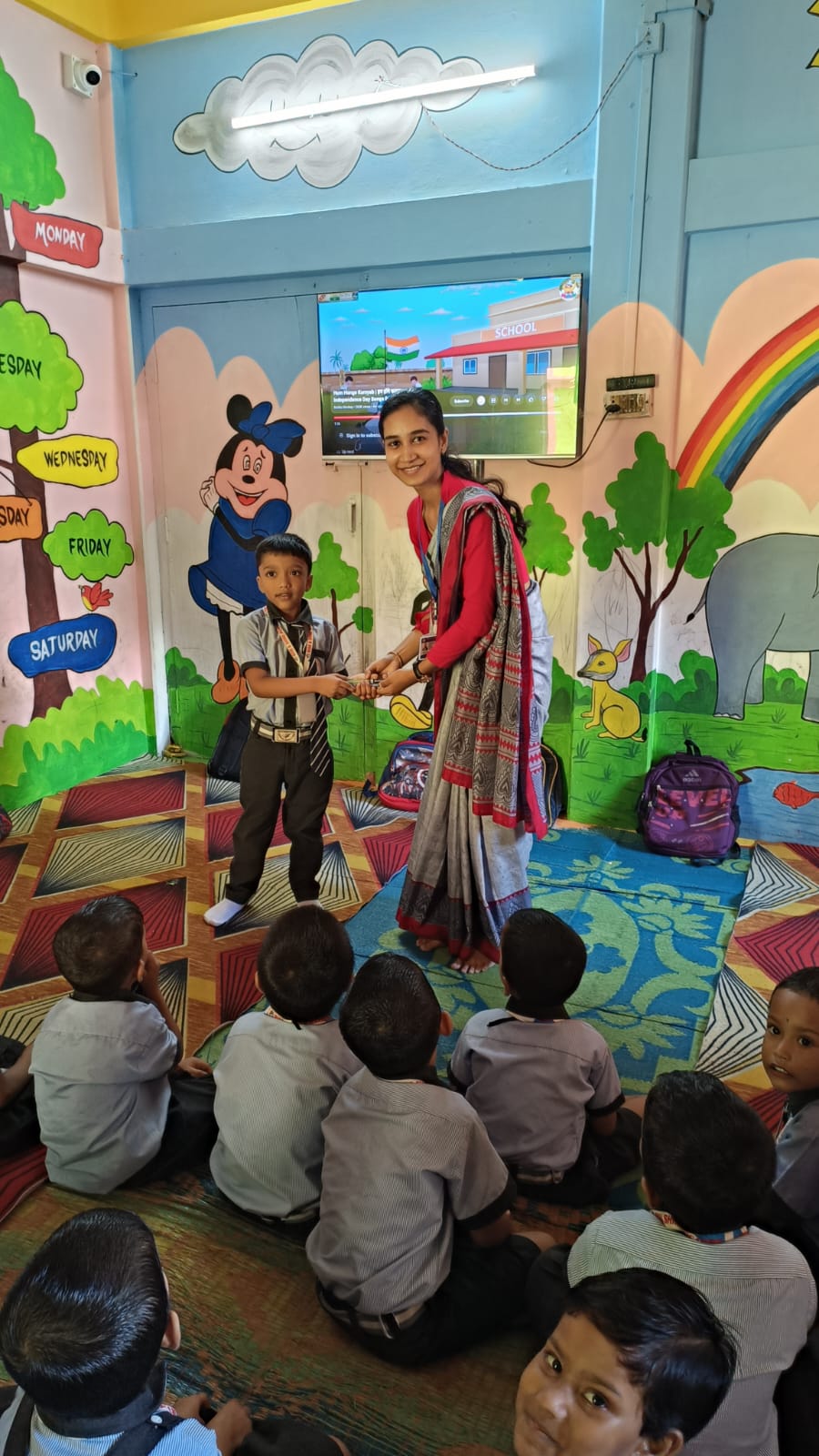 Teacher giving prize to child